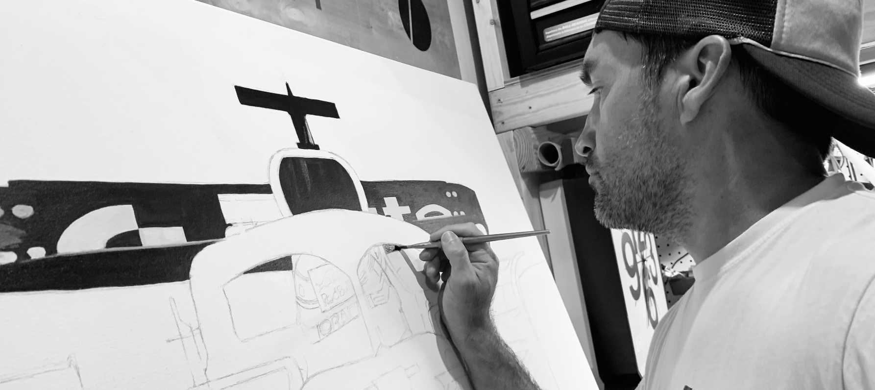 Marty Hoberg painting a racing car on canvas
